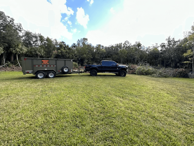 A roll-off dumpster on-site for collecting land clearing debris.